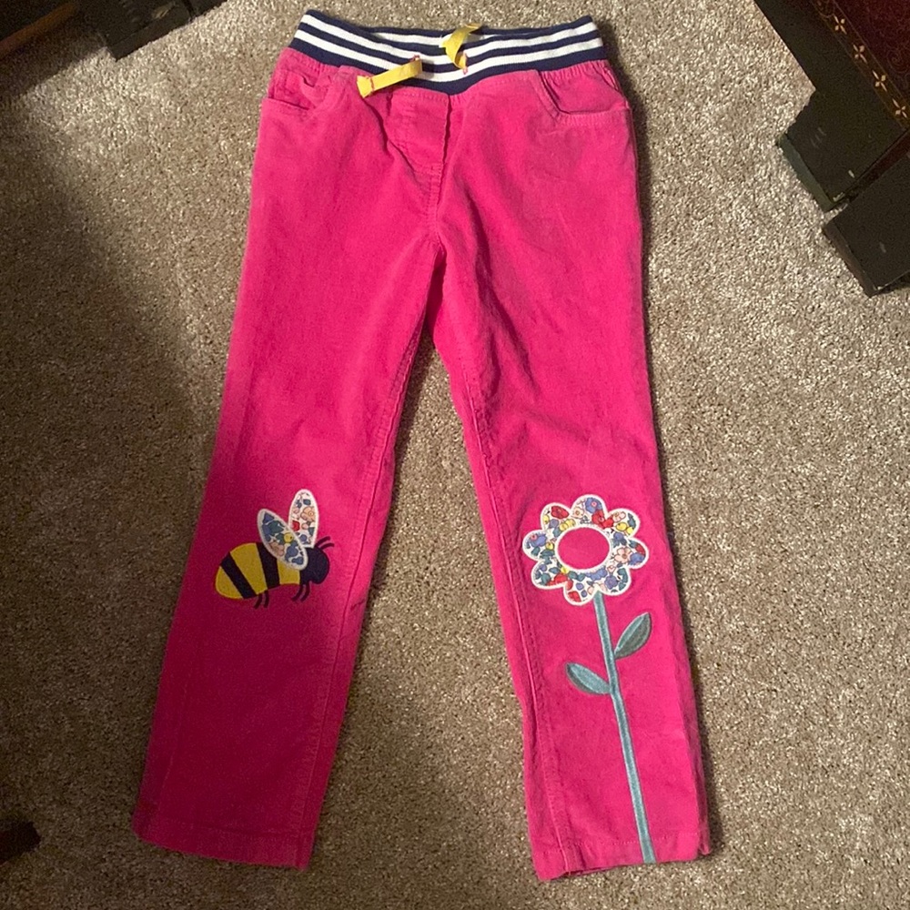 Adorable corduroy pants with bee and flower knees. My daughter wore 1 time.